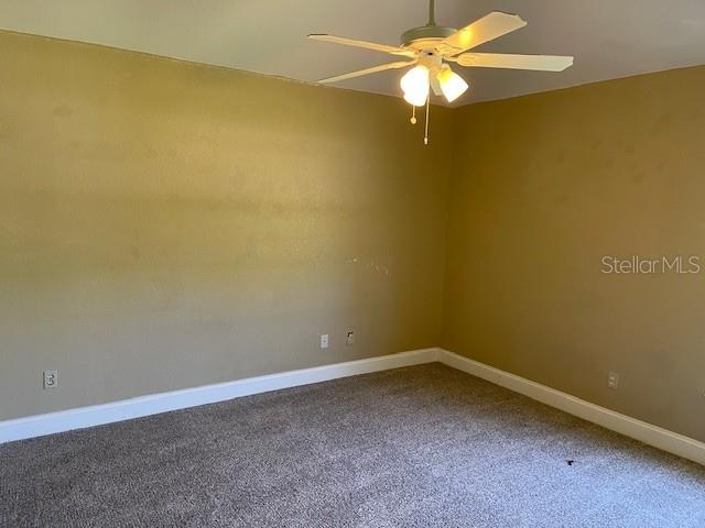 2091 Maltese Ln, New Smyrna Beach, FL 32168 - spare room featuring baseboards, carpet floors, and ceiling fan