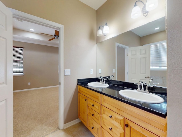 full bathroom featuring double vanity, a sink, baseboards, and ceiling fan
