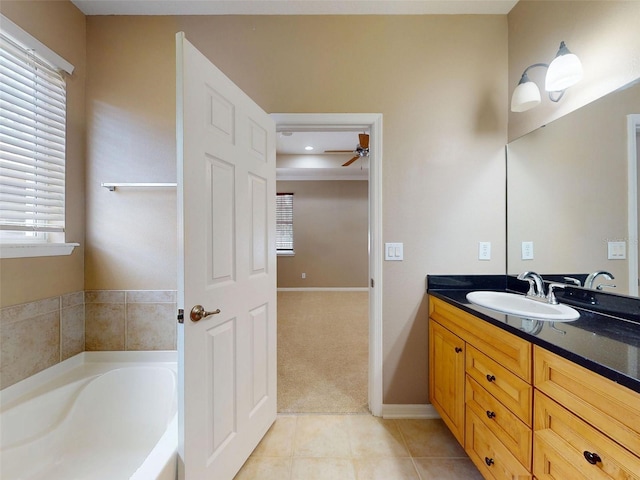 full bath with vanity, tile patterned flooring, a bath, and a healthy amount of sunlight