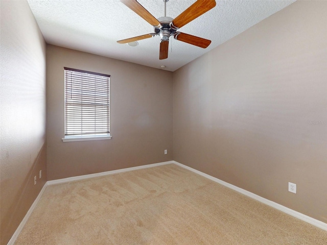 unfurnished room with baseboards, ceiling fan, and carpet flooring