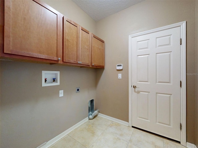 clothes washing area featuring light tile patterned flooring, baseboards, electric dryer hookup, cabinet space, and washer hookup