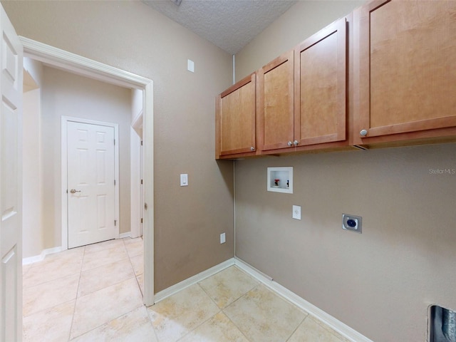 laundry room with washer hookup, electric dryer hookup, cabinet space, baseboards, and light tile patterned flooring
