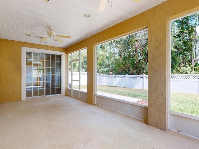 unfurnished sunroom with ceiling fan