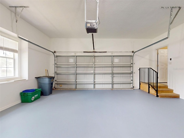 garage with baseboards and a garage door opener