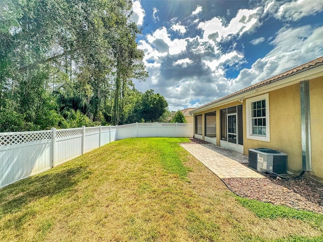 view of yard with a fenced backyard, a patio area, and cooling unit