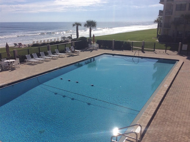 5499 Atlantic Unit 104, New Smyrna Beach, FL 32169 - pool with a patio area, a water view, and fence