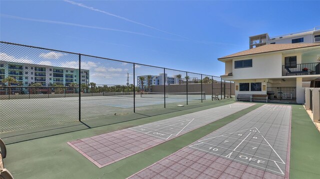 5499 Atlantic Unit 104, New Smyrna Beach, FL 32169 - view of home's community with fence, shuffleboard, and a tennis court