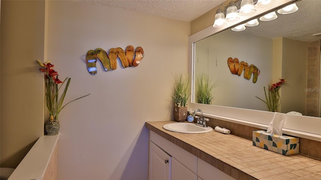 5499 Atlantic Unit 104, New Smyrna Beach, FL 32169 - bathroom featuring a textured ceiling and vanity