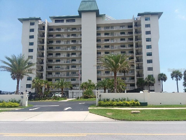 5499 Atlantic Unit 104, New Smyrna Beach, FL 32169 - view of property featuring fence