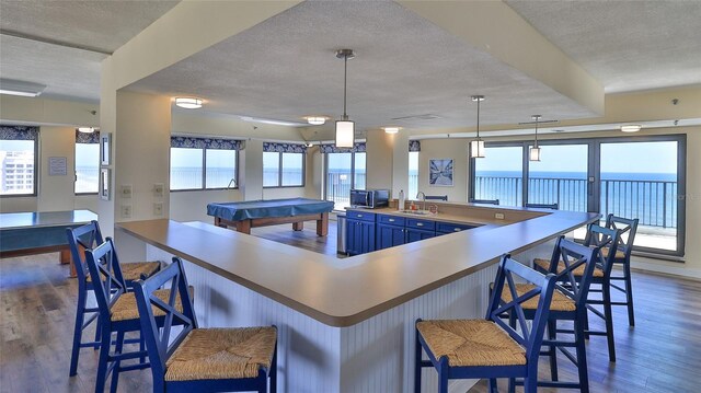 5499 Atlantic Unit 104, New Smyrna Beach, FL 32169 - kitchen with a sink, a textured ceiling, and dark wood-style floors