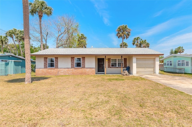 single story home with brick siding, an attached garage, a front yard, and driveway