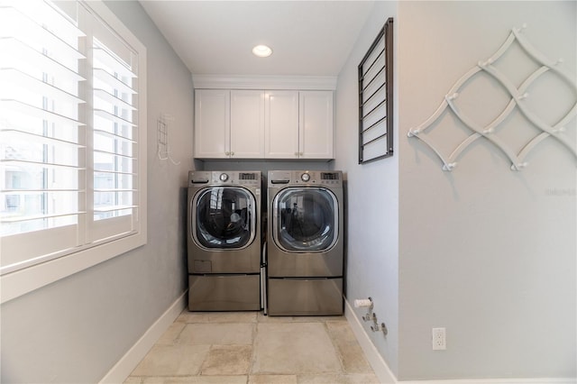 6260 S Atlantic Ave, New Smyrna Beach, FL 32169 - clothes washing area with baseboards, separate washer and dryer, and cabinet space