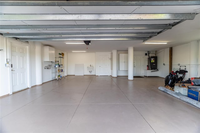 6260 S Atlantic Ave, New Smyrna Beach, FL 32169 - garage with heating unit, a garage door opener, and a sink