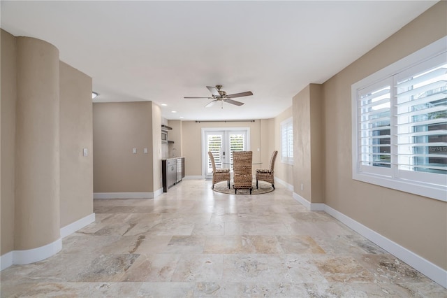 6260 S Atlantic Ave, New Smyrna Beach, FL 32169 - interior space with baseboards, stone finish flooring, and ceiling fan