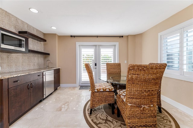 6260 S Atlantic Ave, New Smyrna Beach, FL 32169 - dining area with baseboards, indoor wet bar, marble finish floor, and recessed lighting