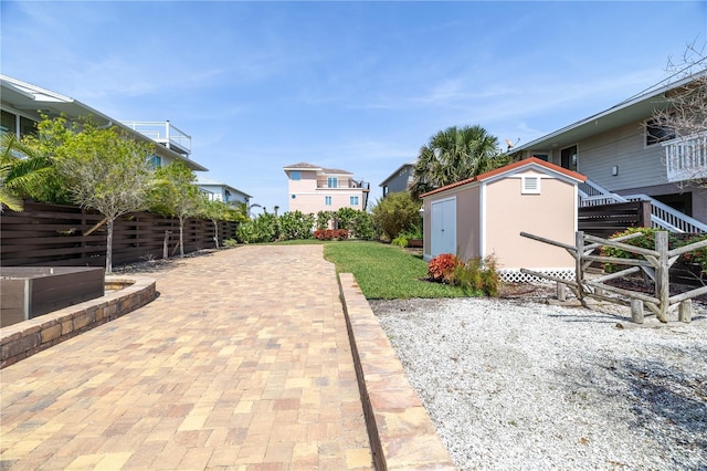 6260 S Atlantic Ave, New Smyrna Beach, FL 32169 - view of yard featuring a storage unit and an outdoor structure