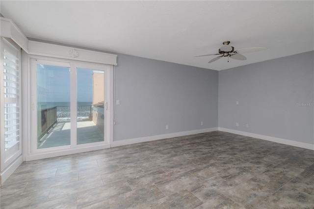 6260 S Atlantic Ave, New Smyrna Beach, FL 32169 - unfurnished room with baseboards and a ceiling fan