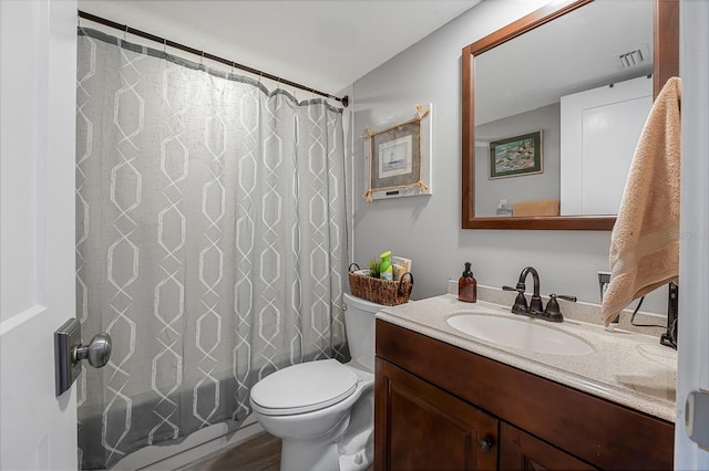 bathroom with toilet, visible vents, shower / bath combo with shower curtain, and vanity