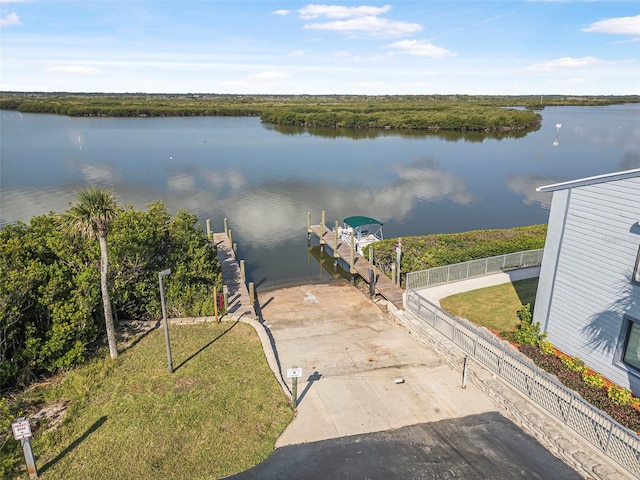 water view featuring a boat dock and fence