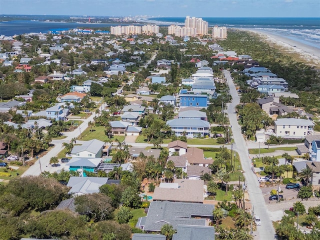 bird's eye view featuring a view of the beach, a water view, and a residential view