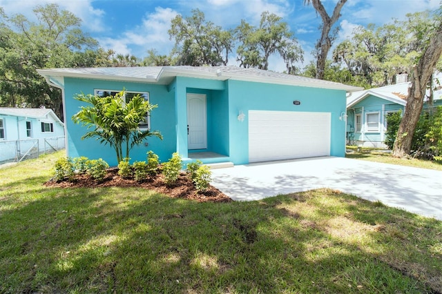 single story home featuring fence, concrete driveway, an attached garage, stucco siding, and a front yard