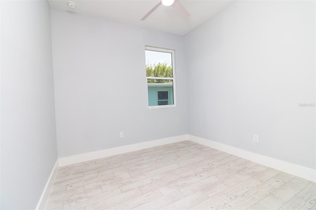 unfurnished room featuring ceiling fan, baseboards, and wood finished floors
