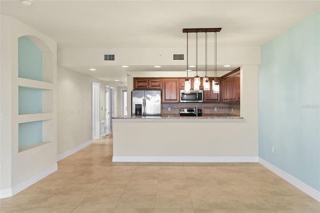 kitchen featuring hanging light fixtures, visible vents, a peninsula, and stainless steel appliances