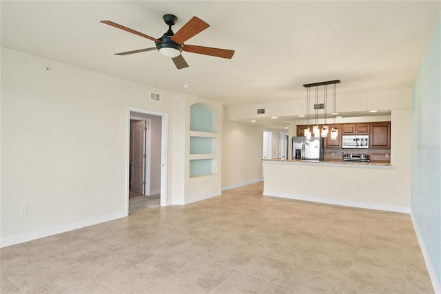 unfurnished living room with visible vents, ceiling fan, and baseboards