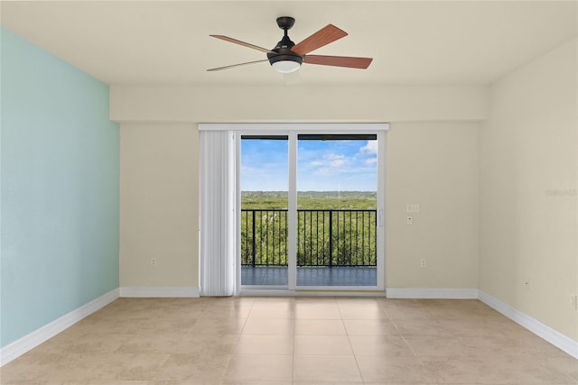 spare room with light tile patterned floors, ceiling fan, and baseboards