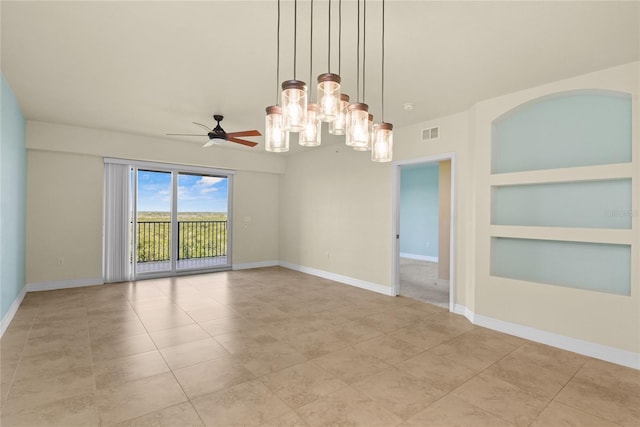 spare room with light tile patterned floors, built in shelves, visible vents, and baseboards