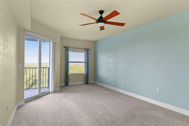 spare room with baseboards, ceiling fan, and carpet floors