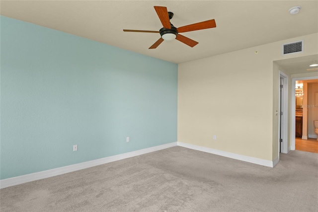 unfurnished room featuring a ceiling fan, visible vents, carpet floors, and baseboards