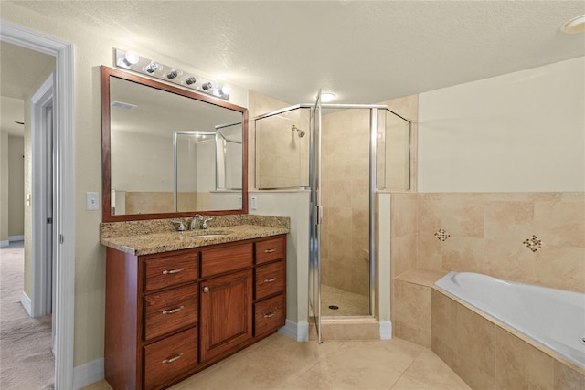 bathroom with tile patterned floors, a stall shower, a bath, and vanity