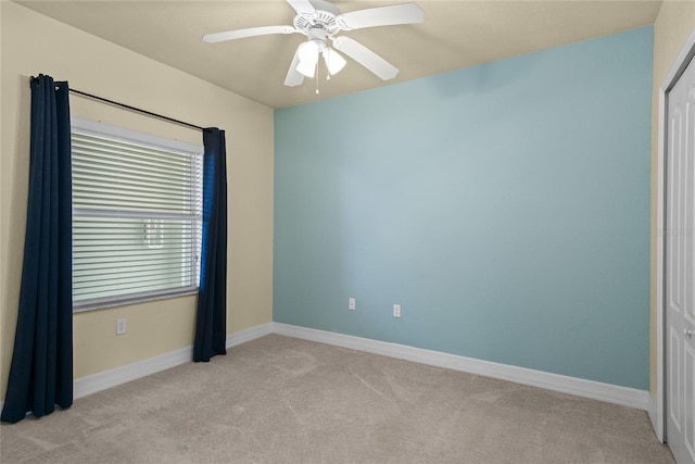 unfurnished bedroom featuring a closet, ceiling fan, light colored carpet, and baseboards