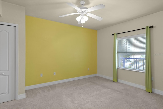 unfurnished bedroom with baseboards, ceiling fan, and light colored carpet