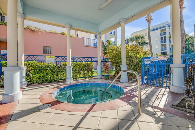 view of swimming pool with a hot tub
