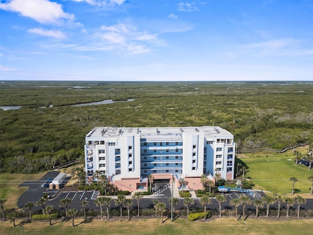 drone / aerial view with a water view and a view of trees