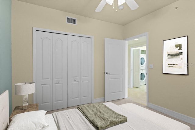 5300 S Atlantic Ave Unit 19-403, New Smyrna Beach, FL 32169 - bedroom with stacked washer / dryer, a closet, baseboards, and a ceiling fan