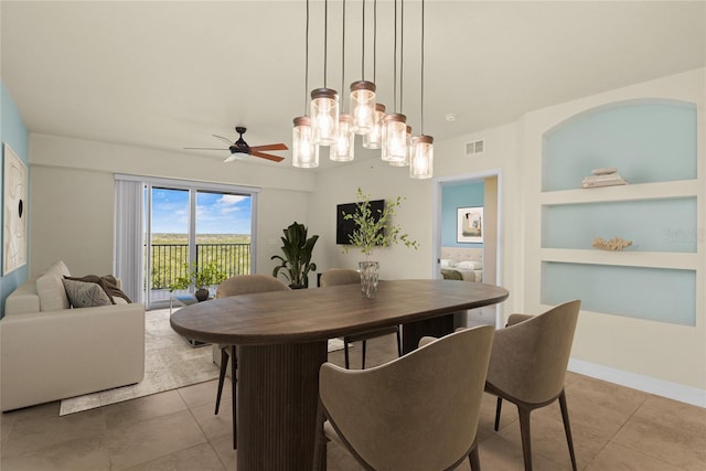 5300 S Atlantic Ave Unit 19-403, New Smyrna Beach, FL 32169 - dining room featuring tile patterned flooring, built in shelves, ceiling fan, and a chandelier