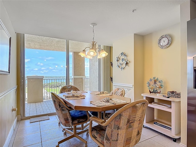 3145 S Atlantic Ave Unit 1001, Daytona Beach, FL 32118 - dining area featuring light tile patterned floors, an inviting chandelier, and baseboards