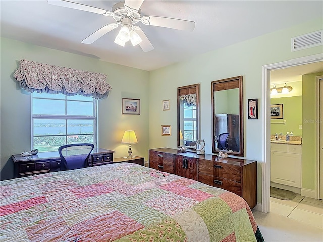 3145 S Atlantic Ave Unit 1001, Daytona Beach, FL 32118 - bedroom with light tile patterned floors, connected bathroom, a sink, ceiling fan, and visible vents