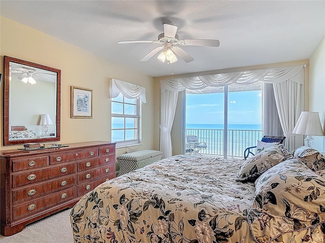 3145 S Atlantic Ave Unit 1001, Daytona Beach, FL 32118 - bedroom featuring access to exterior, ceiling fan, a water view, and light colored carpet