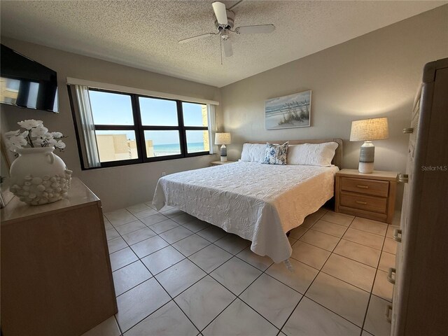 4175 S Atlantic Ave Unit 5280, New Smyrna Beach, FL 32169 - bedroom featuring a textured ceiling, light tile patterned floors, and ceiling fan