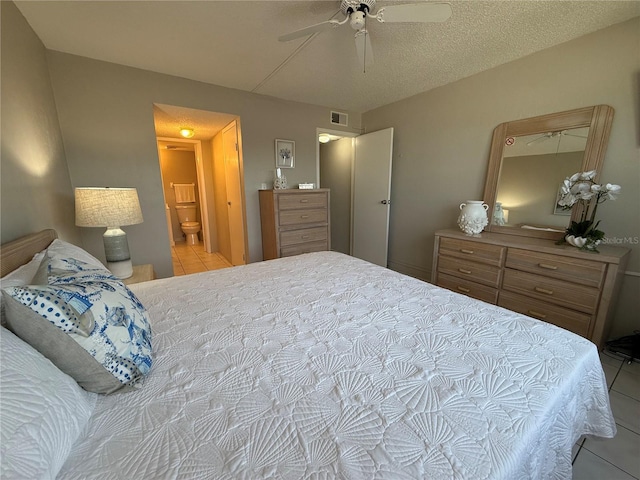 4175 S Atlantic Ave Unit 5280, New Smyrna Beach, FL 32169 - bedroom with light tile patterned flooring, a ceiling fan, and connected bathroom