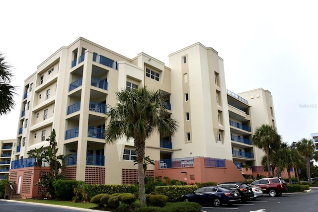 5300 S Atlantic Ave Unit 8-402, New Smyrna Beach, FL 32169 - view of building exterior with uncovered parking