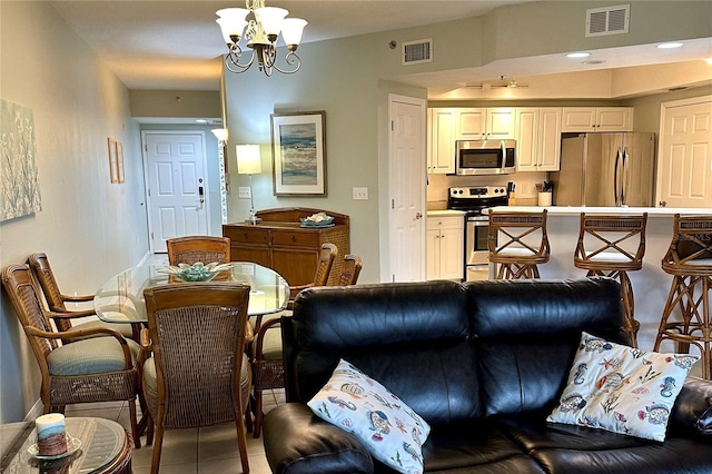 5300 S Atlantic Ave Unit 8-402, New Smyrna Beach, FL 32169 - living room featuring a chandelier, visible vents, and light tile patterned flooring