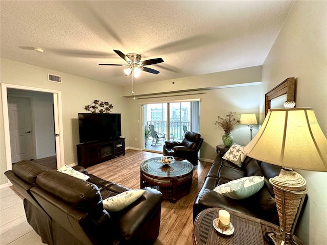 5300 S Atlantic Ave Unit 8-402, New Smyrna Beach, FL 32169 - living area with a ceiling fan, visible vents, baseboards, a textured ceiling, and wood finished floors