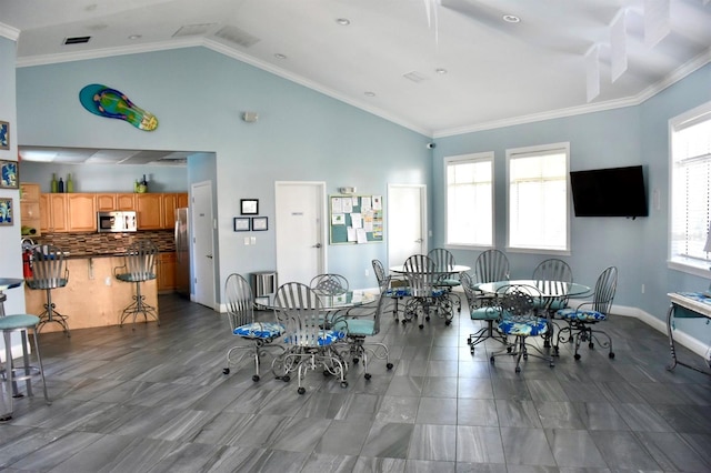 5300 S Atlantic Ave Unit 8-402, New Smyrna Beach, FL 32169 - dining area featuring ornamental molding, visible vents, lofted ceiling, and baseboards