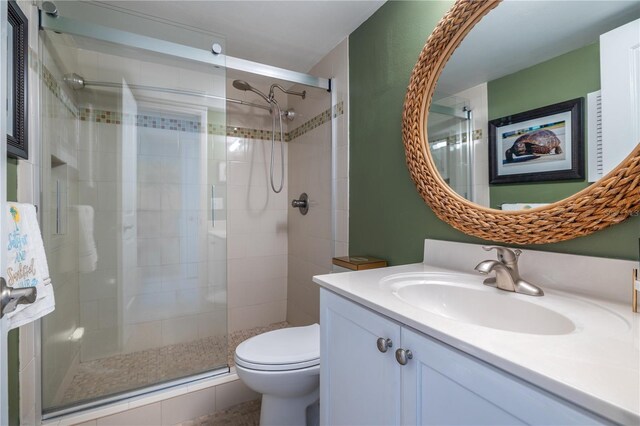 4501 S Atlantic Ave Unit 415, New Smyrna Beach, FL 32169 - full bathroom featuring toilet, a stall shower, and vanity