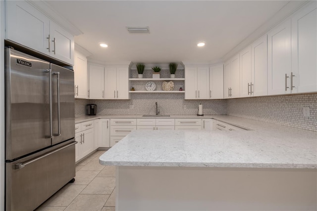 4501 S Atlantic Ave Unit 415, New Smyrna Beach, FL 32169 - kitchen featuring a sink, decorative backsplash, open shelves, visible vents, and high quality fridge
